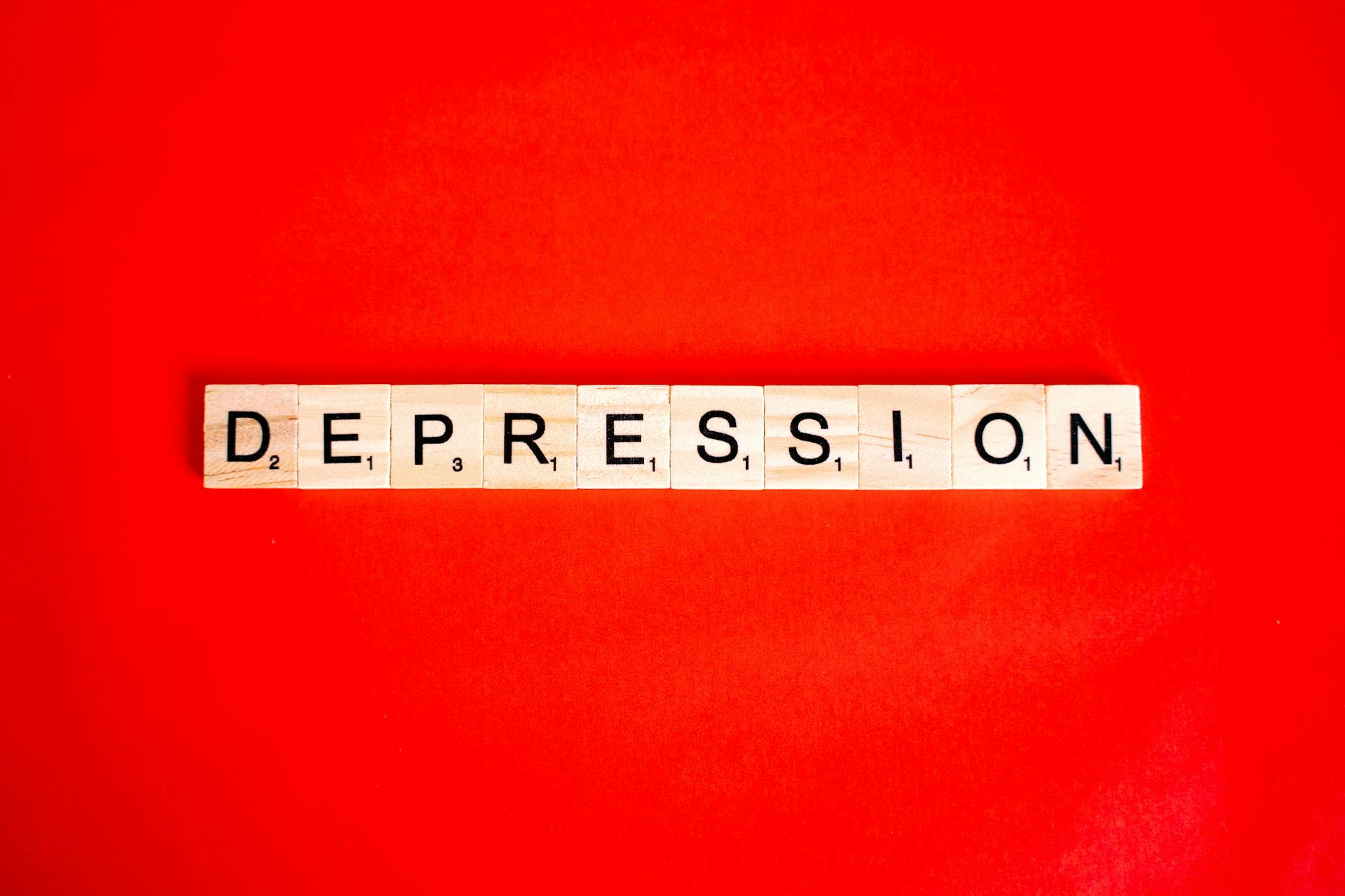 word depression composed of tiles with letters on red background